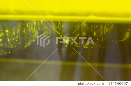 Process working 3D printer. 3D printing from liquid material close-up. Photopolymer hardened under ultraviolet laser. Stereolithography photopolymerization. SLA. Additive manufacturing technology Process working 3D printer. 3D printing from liquid material close-up. Photopolymer hardened under ultraviolet laser. Stereolithography photopolymerization. SLA. Additive manufacturing technology 124540697