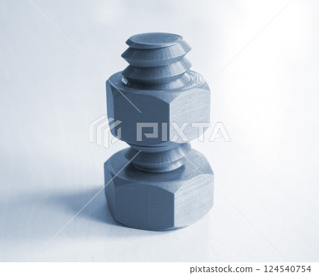 Object in form of washer and bolt printed on 3D printer. Three-dimensional model printed on 3D printer from molten plastic of blue gray color. Concept 3D Printing. FDM 3D Printing technology 124540754
