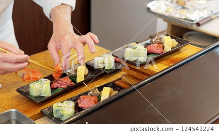 A Japanese chef plating food 124541224