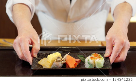 Chef's hands offering food 124541225