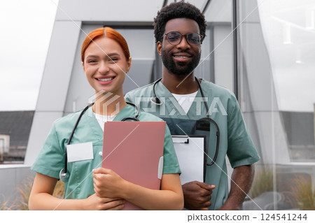 Red haired woman and African American man therapists in hospital office 124541244