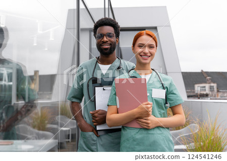 Red haired woman and African American man therapists in hospital office Red haired woman and African American man therapists in hospital office 124541246