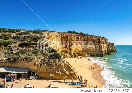 Benagil, Portugal - Feb 19, 2025: Portuguese coast in Benagil, Algarve, Portugal. Seven Hangging Valleys Trail. Benagil, Portugal - Feb 19, 2025: Portuguese coast in Benagil, Algarve, Portugal. Seven Hangging Valleys Trail. 124541267