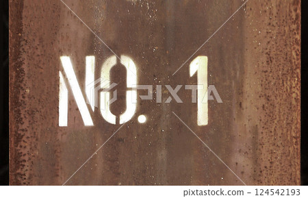 The number NO.1 painted with lacquer spray on a rusted steel beam at a construction site 124542193