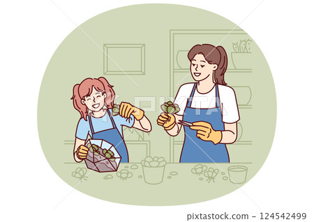 Mom and daughter make diy florarium by planting succulents in transparent aquarium. 124542499