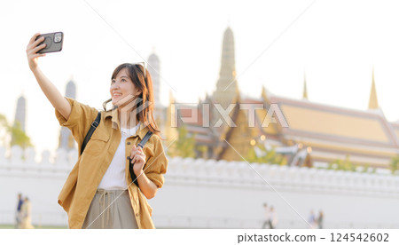 Traveler asian woman in her 30s explores the Grand Palace with a local guide. Uncover hidden gems and immerse yourself in Thai culture with her adventure. Traveler asian woman in her 30s explores the Grand Palace with a local guide. Uncover hidden gems and immerse yourself in Thai culture with her adventure. 124542602