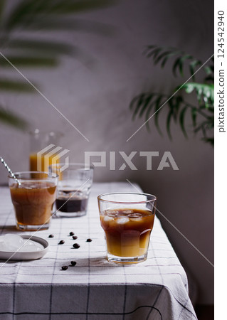 Refreshing bumble coffee, orange juice espresso, iced orange juice coffee on a wooden table with coffee beans around, summer concept 124542940