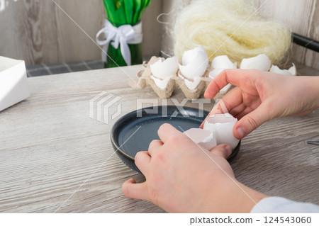 Tutorial How to make Easter table decoration with egg shells step by step instruction. Easter home decoration on wooden branch. Seasonal sustainable recycled 124543060