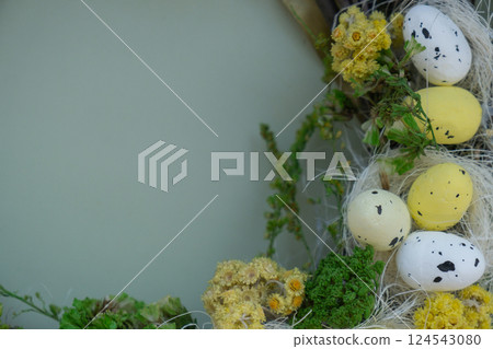 Handmade Easter wreath festive yellow egg decorations. Traditional holiday preparation craft creative decor. Sustainable responsible holiday gift workshop creation. Copy space Simple ideas Handmade Easter wreath festive yellow egg decorations. Traditional holiday preparation craft creative decor. Sustainable responsible holiday gift workshop creation. Copy space Simple ideas 124543080