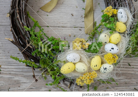 Handmade Easter wreath festive yellow egg decorations. Traditional holiday preparation craft master class of creative making decor. Hands-on activities sustainable responsible holiday gift workshop 124543081