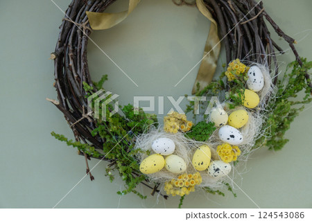 Candid Easter wreath arrangement decor. Handmade craft creative present or gift idea. Zero waste eco-friendly springtime holiday Candid Easter wreath arrangement decor. Handmade craft creative present or gift idea. Zero waste eco-friendly springtime holiday 124543086
