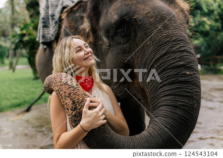 beautiful girl with smiling elephant, elephant village, bali 124543104