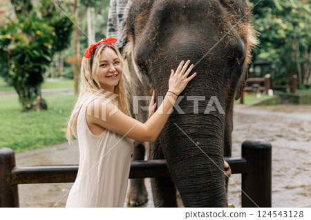 beautiful girl with smiling elephant, elephant village, bali beautiful girl with smiling elephant, elephant village, bali 124543128