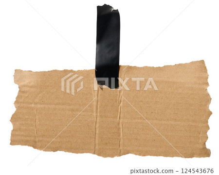 Torn piece of brown corrugated cardboard attached to black piece of electrical tape, isolated background Torn piece of brown corrugated cardboard attached to black piece of electrical tape, isolated background 124543676