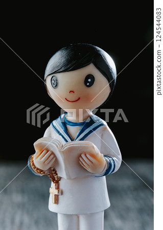 closeup of a figurine of a first communion boy closeup of a figurine of a first communion boy 124544083