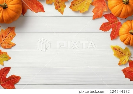 Orange pumpkins with red and yellow autumn leaves on wooden background 124544182