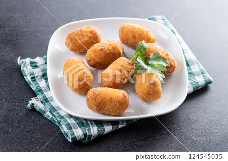 Fried cod croquettes on wooden tableFried cod croquettes on wooden table 124545035