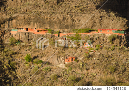 Earth shelters in a cliff. Earth shelters in a cliff. 124545128