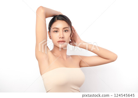 Beautiful Young Asian woman Raises her hands to Showcase clean and hygienic underarms Against a white background, Smooth armpit cleanliness and protection concept 124545645