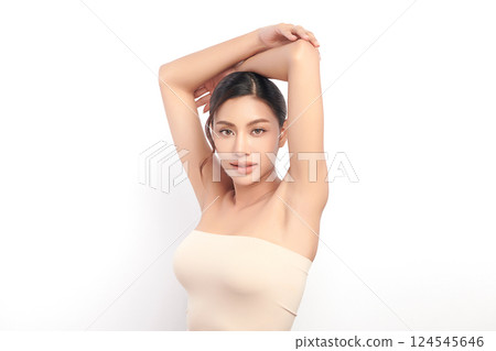 Beautiful Young Asian woman Raises her hands to Showcase clean and hygienic underarms Against a white background, Smooth armpit cleanliness and protection concept 124545646