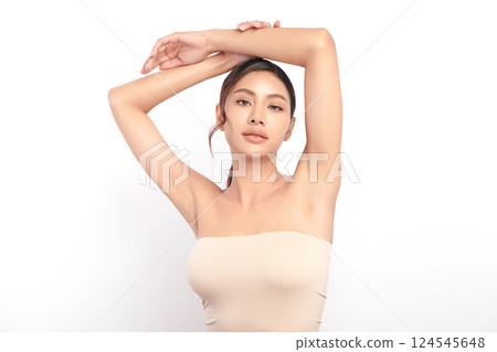 Beautiful Young Asian woman Raises her hands to Showcase clean and hygienic underarms Against a white background, Smooth armpit cleanliness and protection concept 124545648