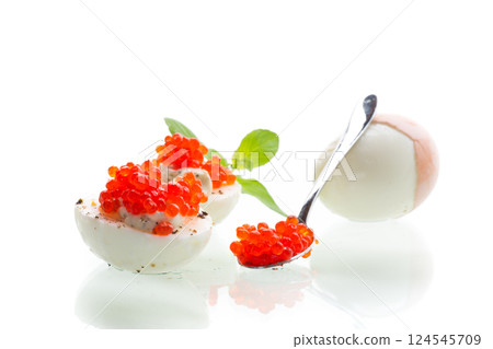 boiled eggs with red caviar on a white background boiled eggs with red caviar on a white background 124545709