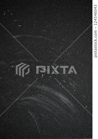 Dark textured surface featuring chalk board residue and scratches, showcasing signs of wear and age, creating a gritty, abstract background Dark textured surface featuring chalk board residue and scratches, showcasing signs of wear and age, creating a gritty, abstract background 124546043