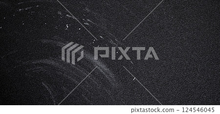 Dark textured surface featuring chalk residue and scratches, showcasing signs of wear and age, creating a gritty, panorama banner abstract background Dark textured surface featuring chalk residue and scratches, showcasing signs of wear and age, creating a gritty, panorama banner abstract background 124546045