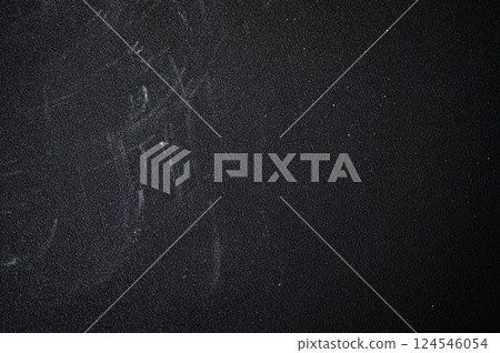 Flour dusting a dark chalk board, textured surface, creating a perfect background for baking. Scattered white powder adds a rustic, culinary touch 124546054