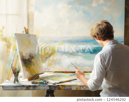 Young artist painting a seascape in a bright studio 124546292