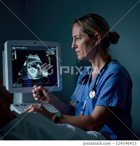 Female healthcare professional conducting ultrasound examination on adult patient 124546413