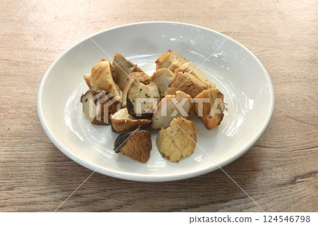 slice grilled king oyster mushroom or Enoki dressing salt and black pepper on plate 124546798