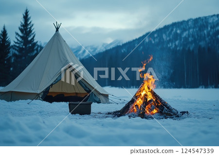Campfire Glowing Brightly in Winter Landscape 124547339