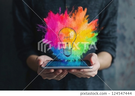 Creative Hands Holding Tablet with Colorful Design Creative Hands Holding Tablet with Colorful Design 124547444