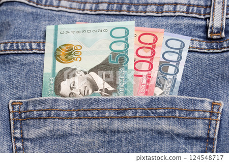Dominican pesos in the pocket of blue jeans 124548717
