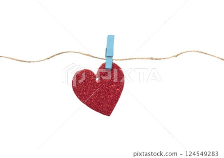 Paper heart with glitter hanging on a rope with a clothespin. Heart isolated on white background Paper heart with glitter hanging on a rope with a clothespin. Heart isolated on white background 124549283