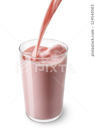strawberry milk pouring into glass isolated on white background 124549363