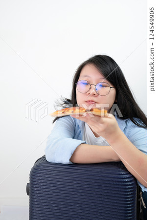 Happy glasses Asian young woman eat Pizza on white background. 124549906