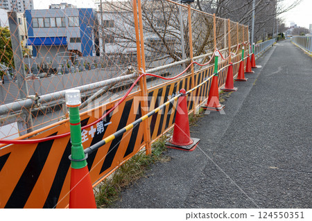 Partition fence and traffic cones at a construction site Partition fence and traffic cones at a construction site 124550351