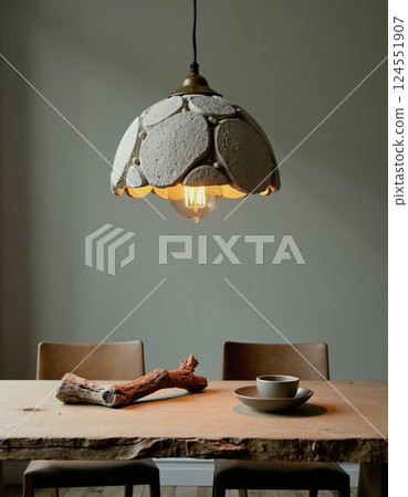 Rustic dining setting with unique hanging lamp and earthy decor 124551907