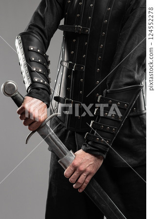 Person Wearing Black Widow Leather Bracers Holding Sword 124552278
