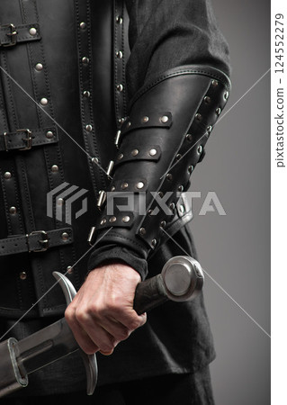 Person Wearing Black Widow Leather Bracers Holding Sword 124552279