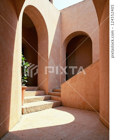 Sunlit mediterranean architecture with arched doorways and staircase 124552405