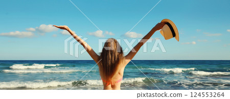 Summer vacation, beautiful happy woman in bikini swimsuit raising her hands up on the beach at sea Summer vacation, beautiful happy woman in bikini swimsuit raising her hands up on the beach at sea 124553264