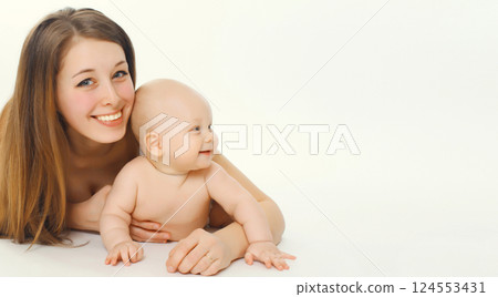 Portrait of happy smiling young mother playing with cute baby lying together on white background Portrait of happy smiling young mother playing with cute baby lying together on white background 124553431