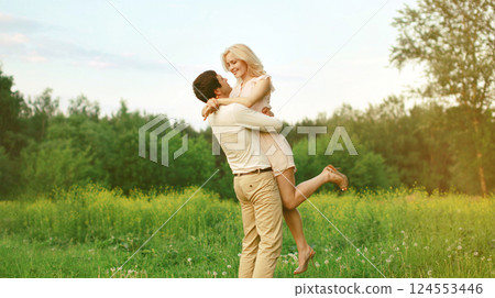 Portrait of beautiful happy smiling young couple in love together hugging in summer park 124553446