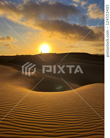 People watching a colorful sunset at a Maspalomas dune, Gran Canaria island People watching a colorful sunset at a Maspalomas dune, Gran Canaria island 124553485