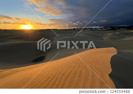A colorful sunset at a Maspalomas dune, Gran Canaria island A colorful sunset at a Maspalomas dune, Gran Canaria island 124553488