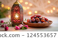 Traditional Lantern with Dates and Flowers on a Soft Background 124553657