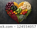 Heart shape made of fresh vegetables on dark background. Healthy food concept. top view 124554057